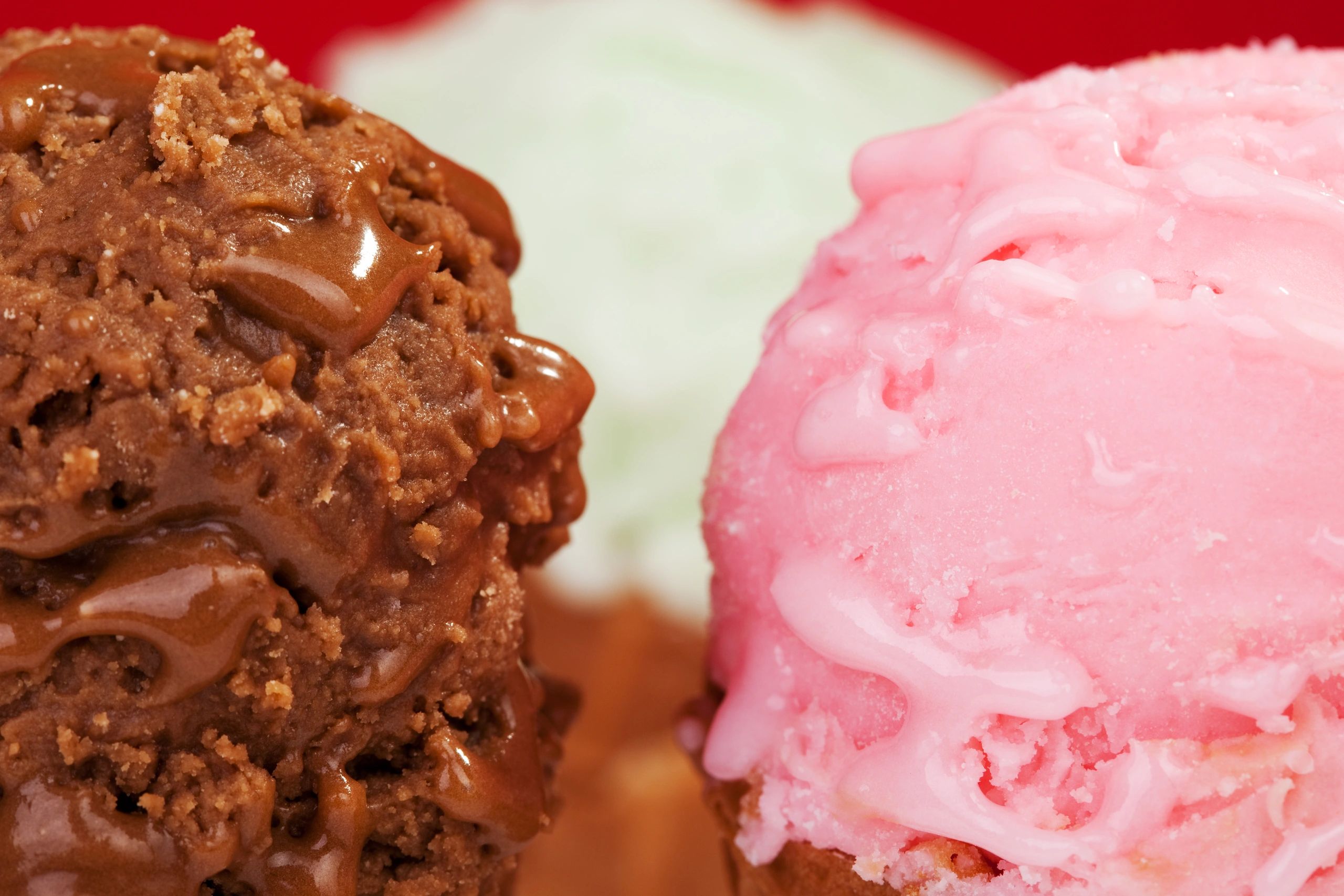Close-up of strawberry, chocolate and vanilla ice cream scoops