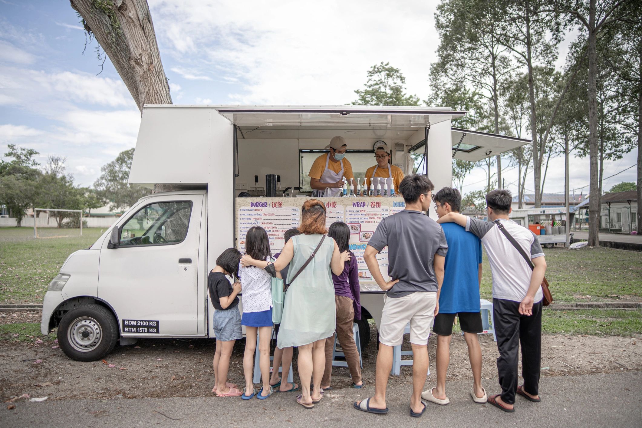 Guests ordering treats at a vintage-style ice cream van
