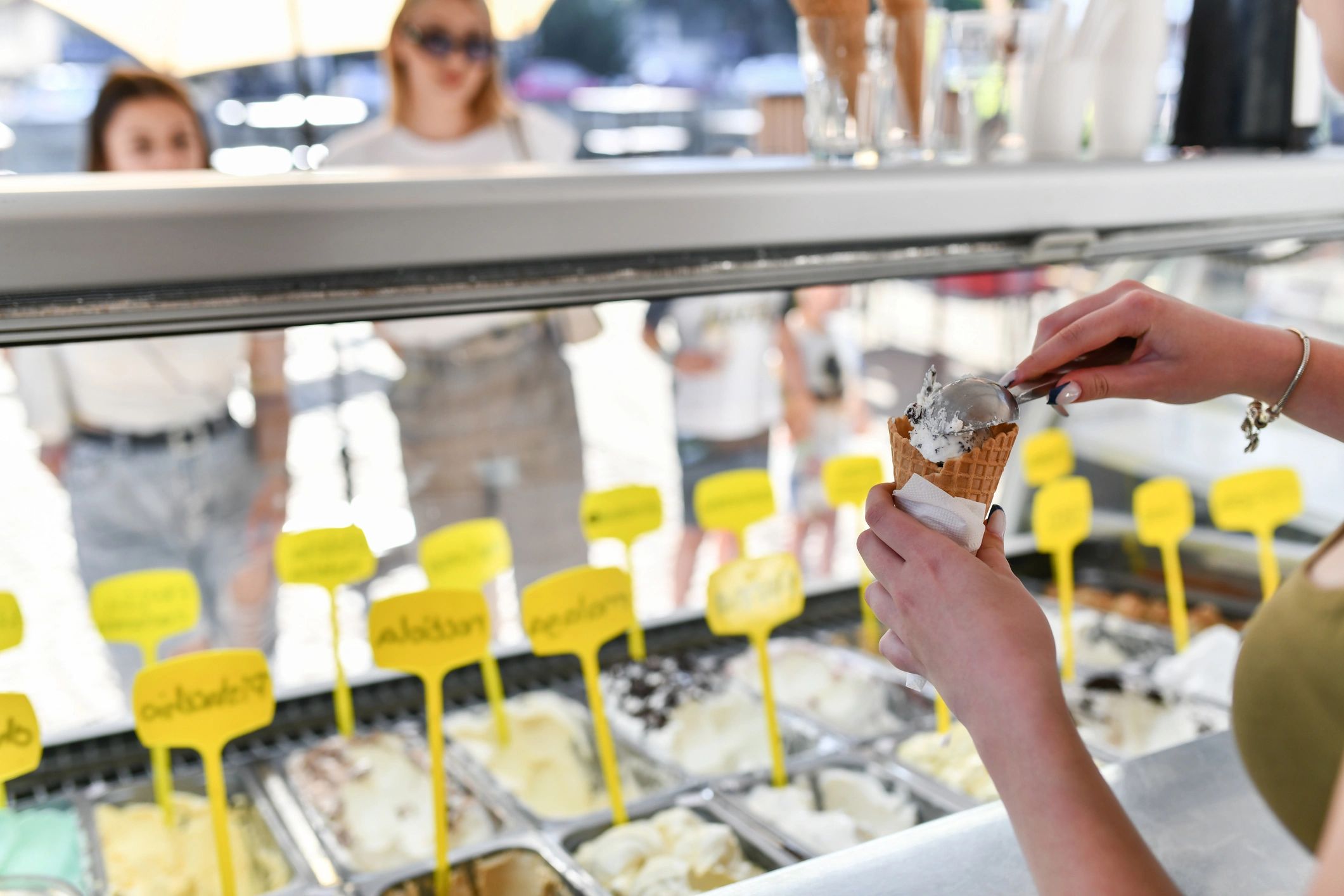 Scoops of ice cream being stacked into a cone