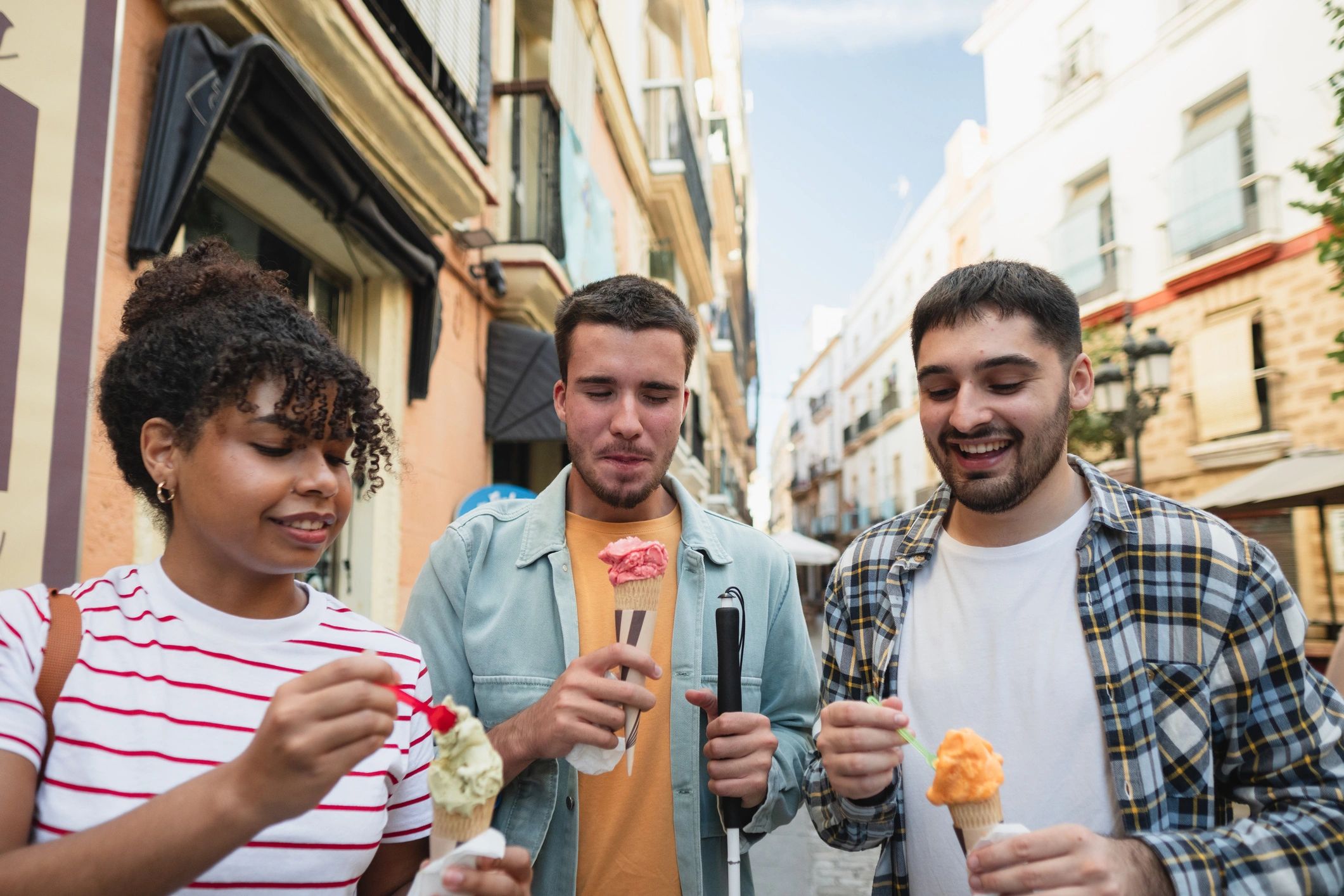 Friends enjoying ice cream cones on a sunny day