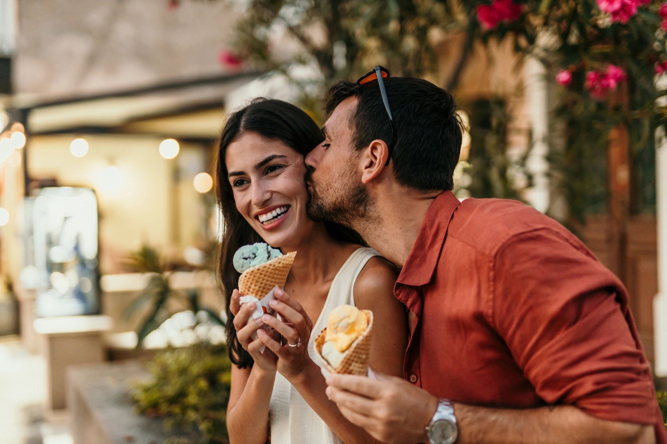 Couple enjoying ice cream while walking outdoors