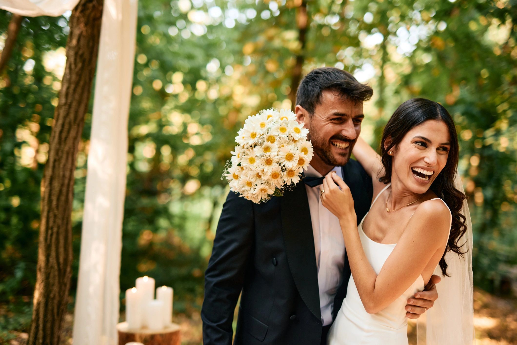 Happy newlyweds hugging outdoors