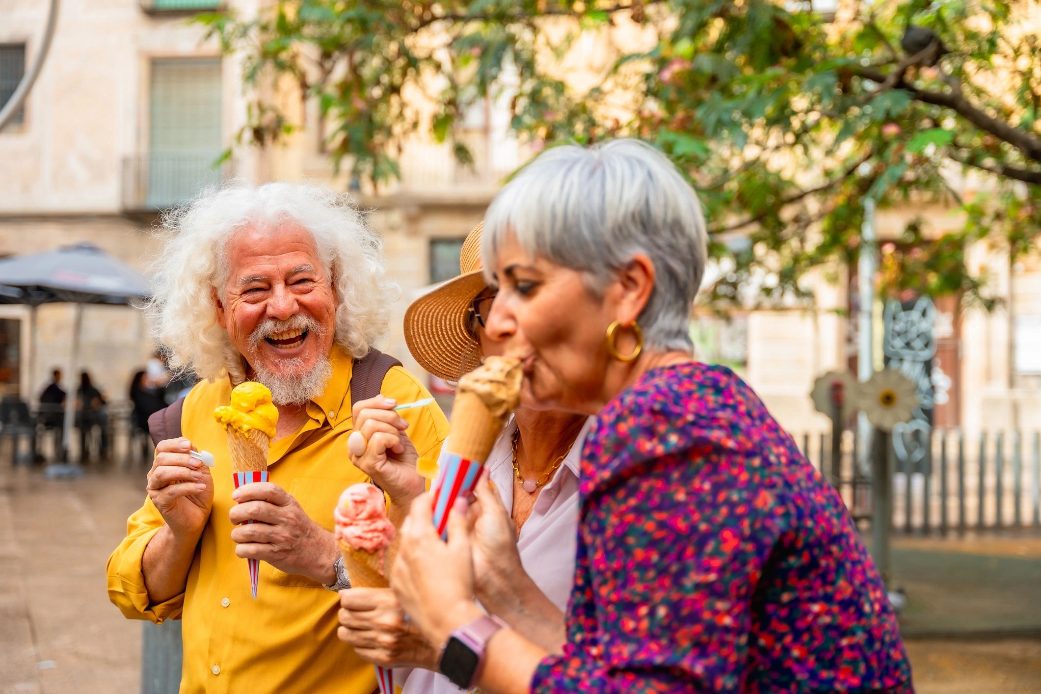 Friends enjoying ice cream together on a city street